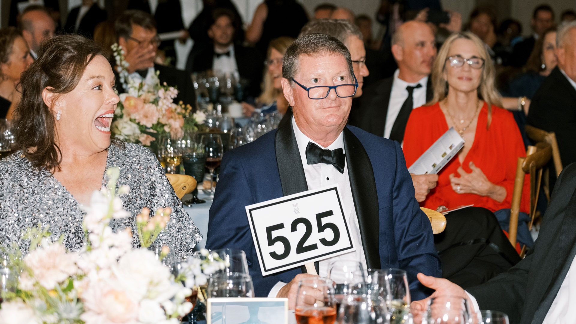 man holding auction sign